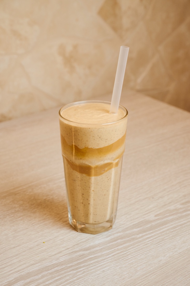 A creamy URTH smoothie served in a tall glass